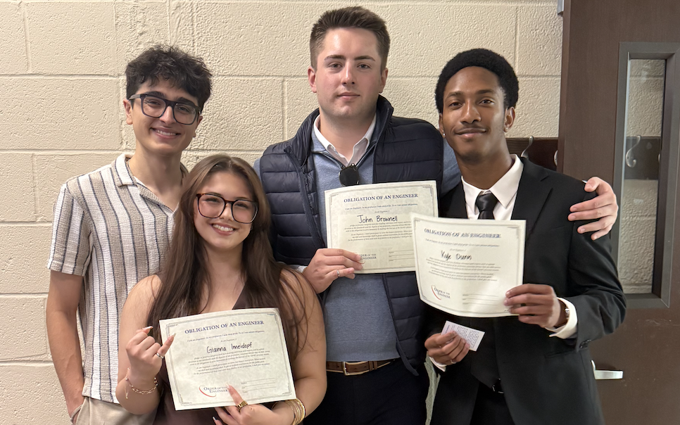 Gianna and classmates holding Engineering Ring Ceremony certificates